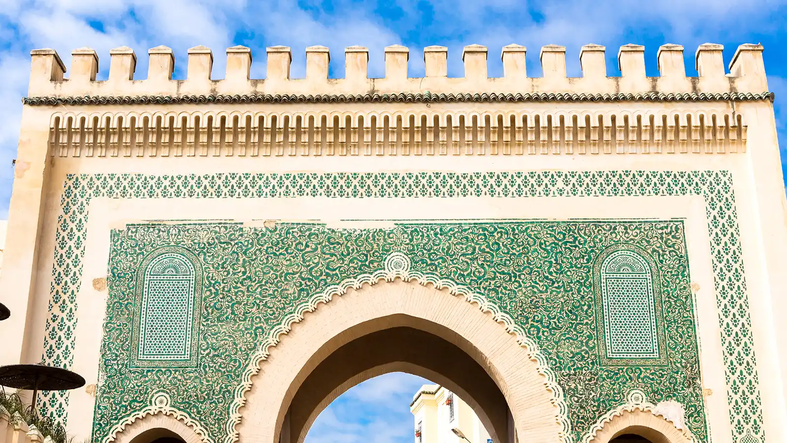 Fes medina guided tour at an ancient medina gate with Moroccan architectural details